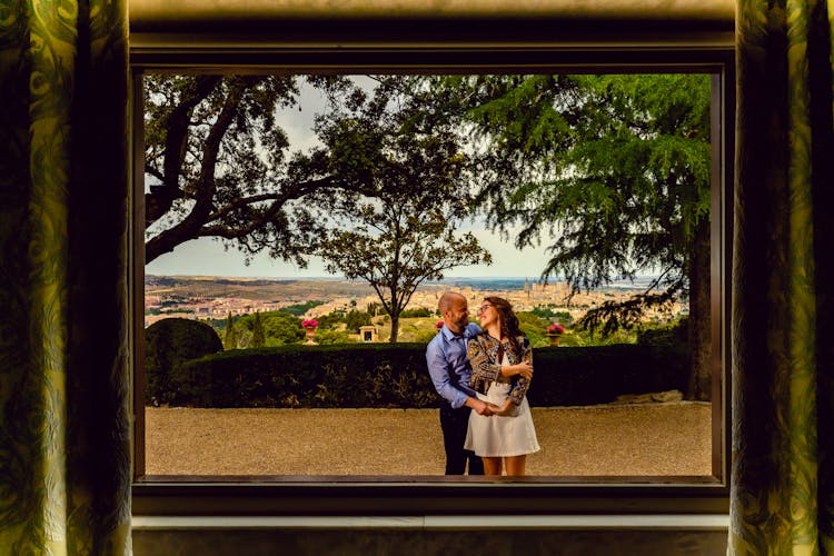 Reflection In The Window Of A Couple Smiling