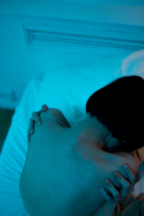 Man in Black Shirt Lying on Bed