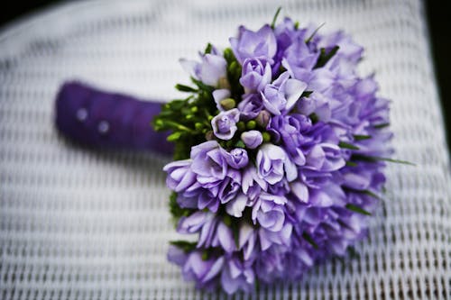 Purple Flower Bouquet on White Woven Chair