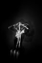 Graceful woman touching head in studio