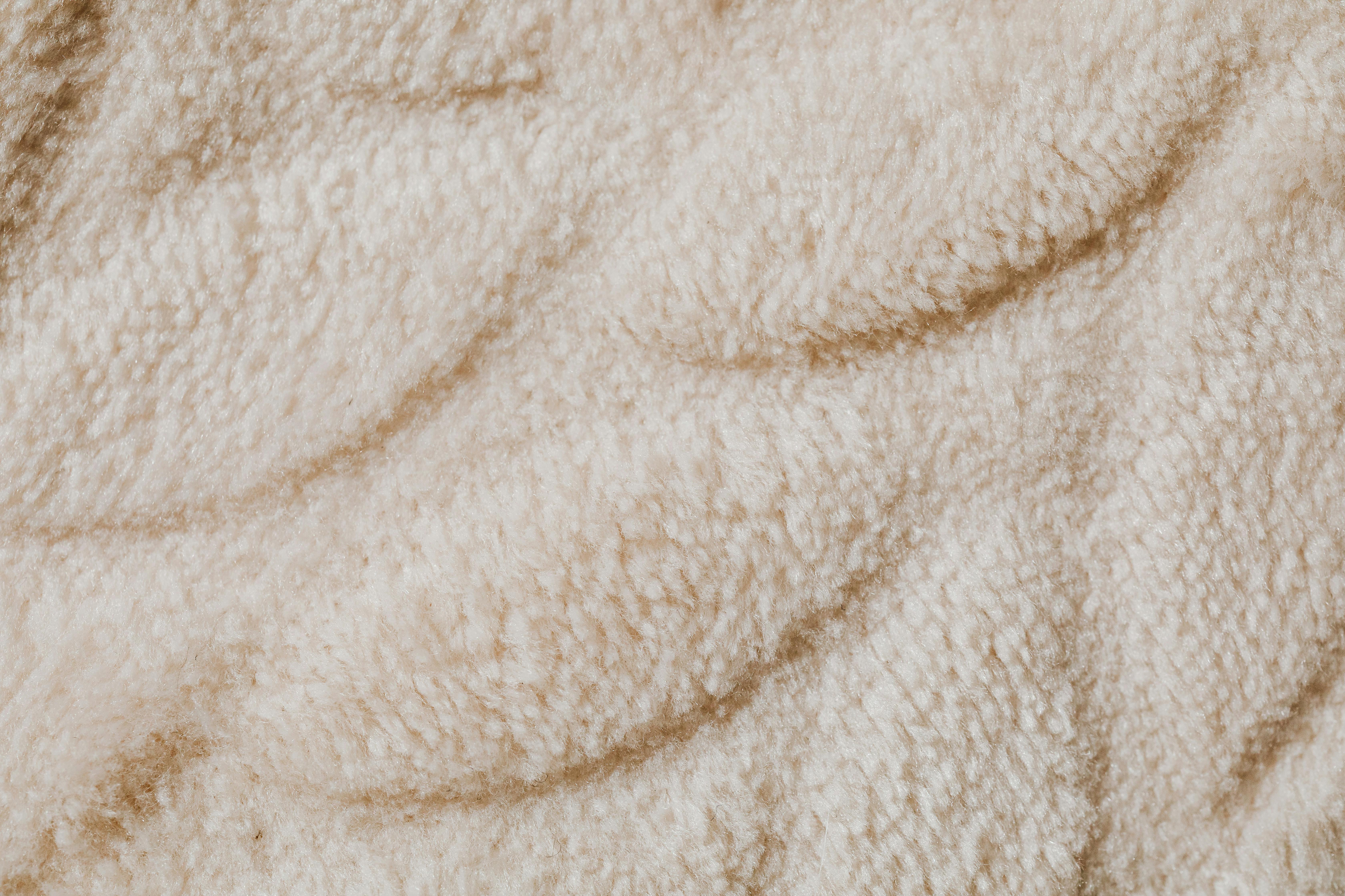 Brown sherpa textured plush fabric material background Stock Photo