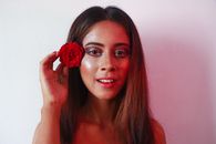 Young woman with red flower in hair