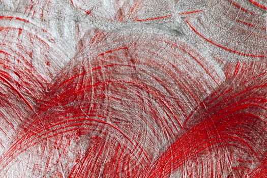 Close-up of red and silver abstract texture, showcasing vivid brushstrokes and creative design.