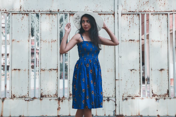 Stylish Woman In Blue Dress Standing In Gateway