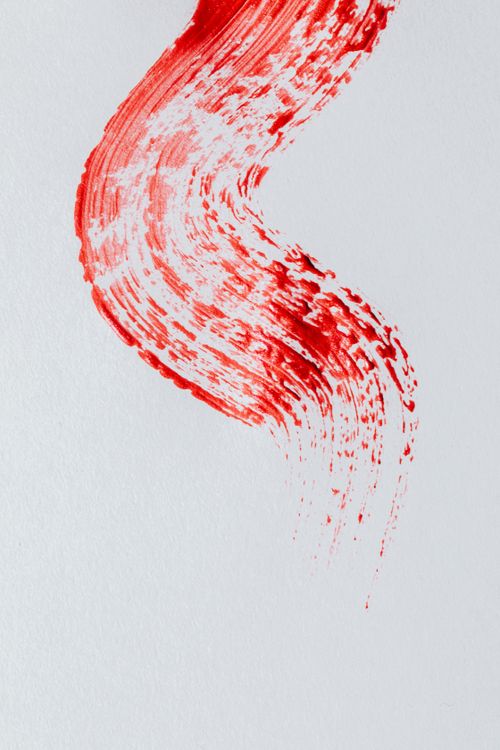 Free Abstract red paint stroke on white background, capturing dynamic brush movement. Stock Photo
