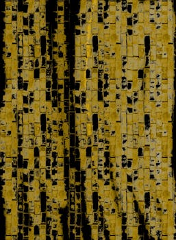 Abstract vertical shot of a yellow and black textured brick wall pattern.