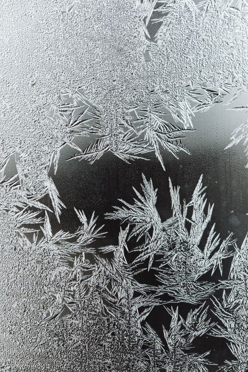 Free Close-up of frosty patterns forming intricate designs on glass, showcasing winter's beauty. Stock Photo