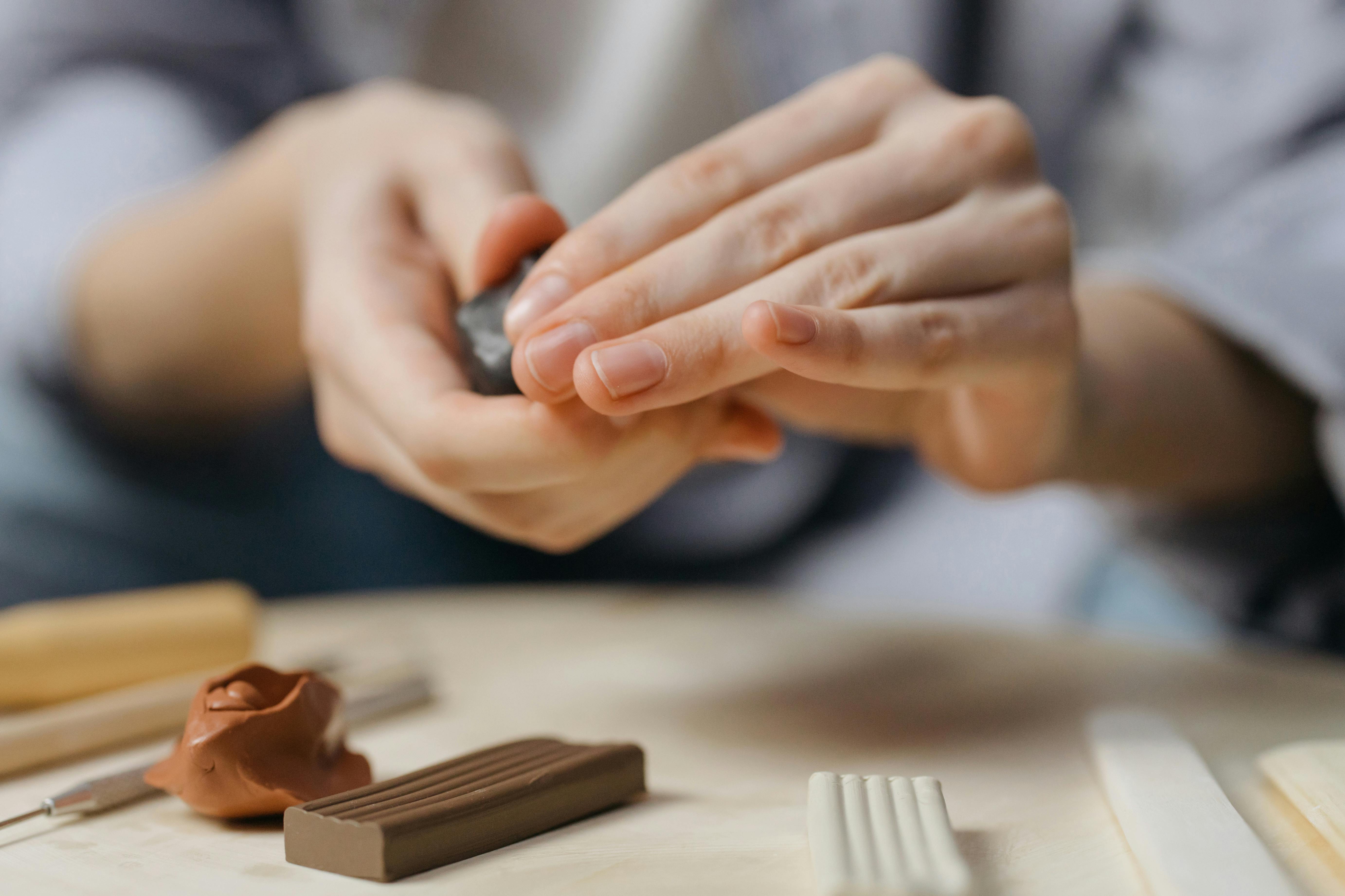 woman modeling figurine of vagina in hands