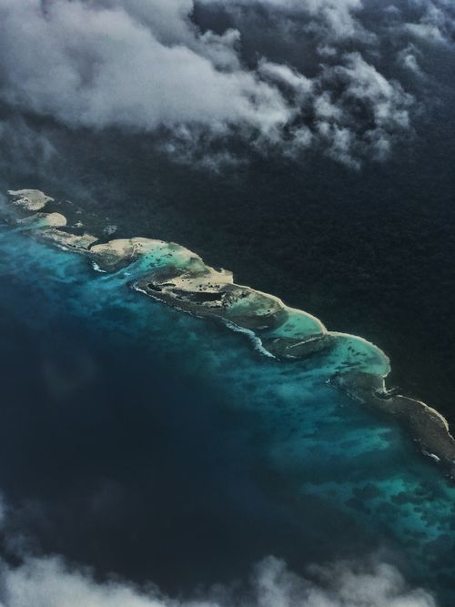 Free Drone view of picturesque scenery of green tropical coastline with turquoise water Stock Photo