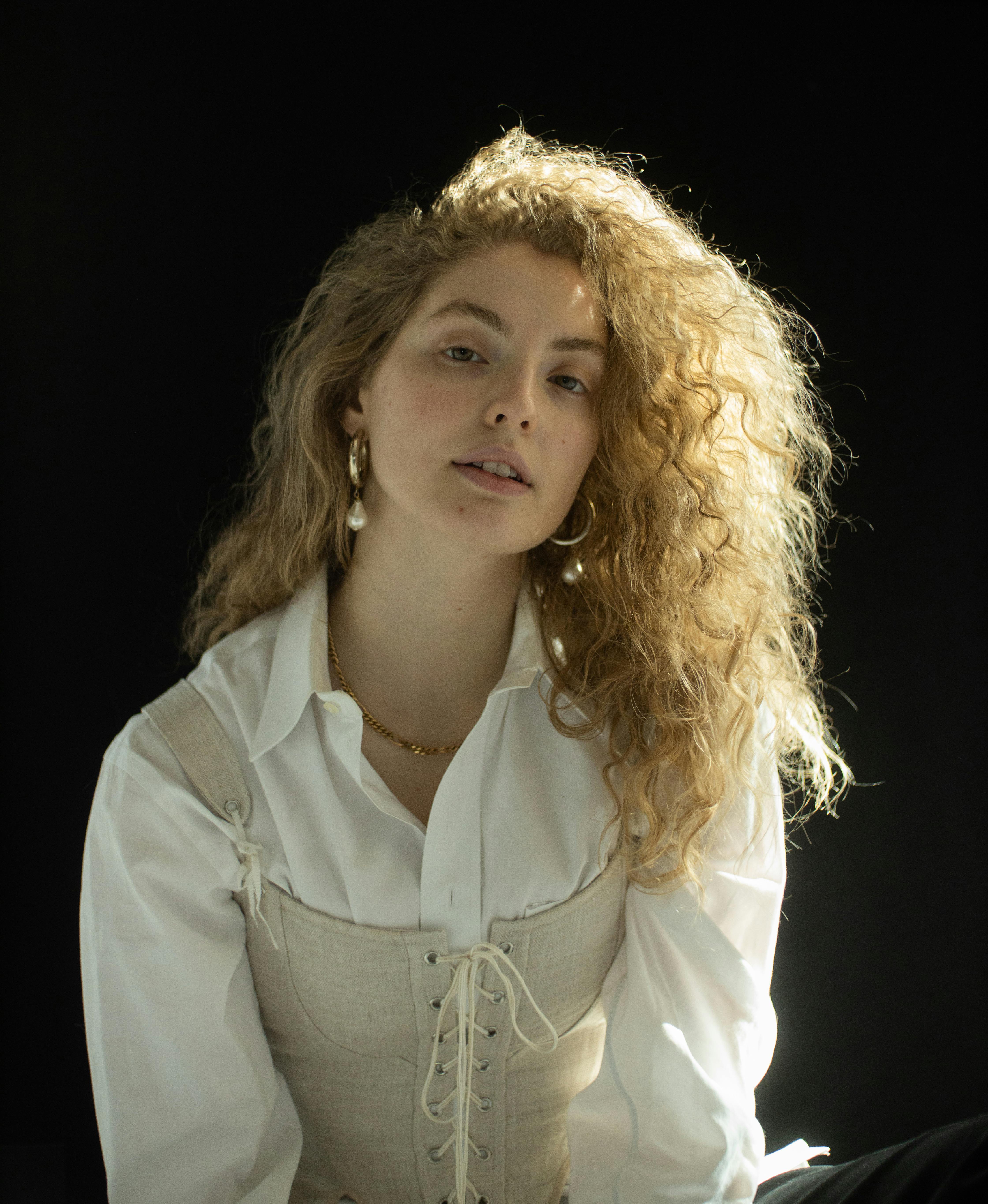 woman with curly fair hair in stylish outfit