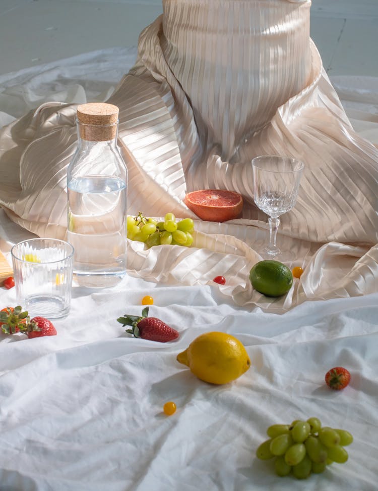 Woman Near Bottle With Water And Fresh Berries And Fruits