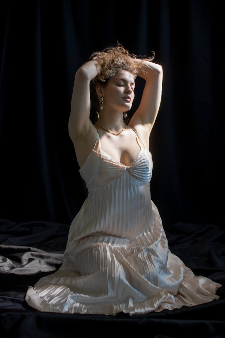 Graceful Woman In Dress In Dark Studio