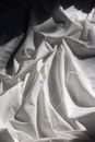 Draped fabric on bed in sunlight