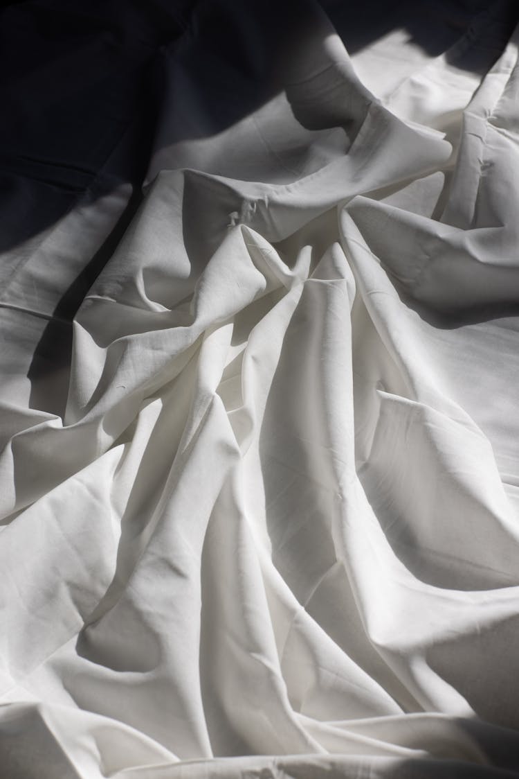 Draped Fabric On Bed In Sunlight