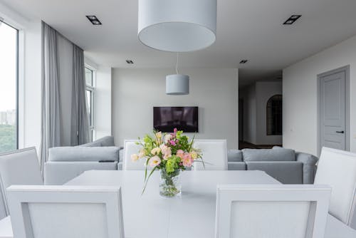 Free Table with gentle flowers in spacious apartment Stock Photo