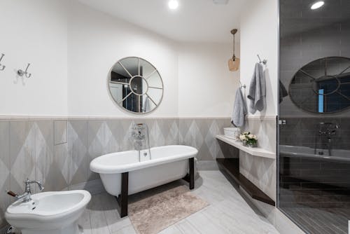 Contemporary bathroom with round shaped mirror