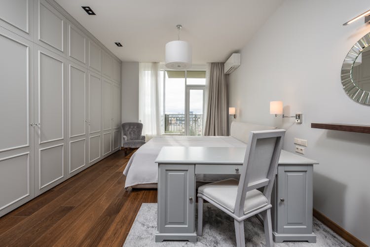 Interior Of Light Bedroom With Table And Chair