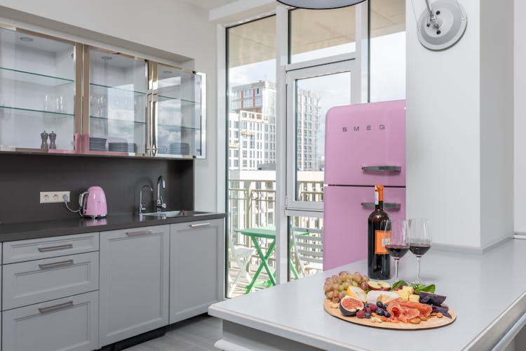 Delicious Food And Bottle Of Wine Place On Kitchen Table In Daytime