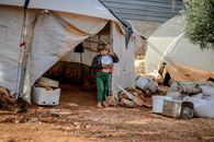 Little kid near shabby tent