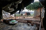 Shabby tent with belongings in countryside