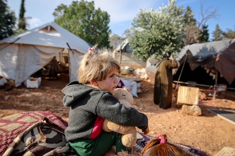 Cute Girl With Toy In Refugee Camp