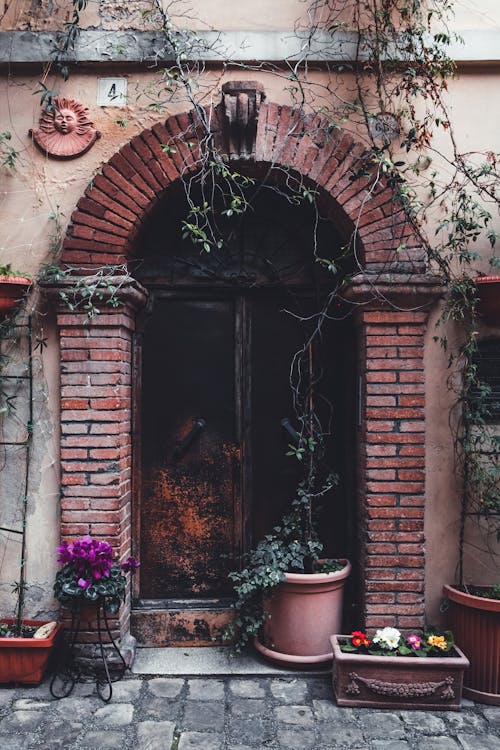 Brown Wooden Door on the Brick Wall