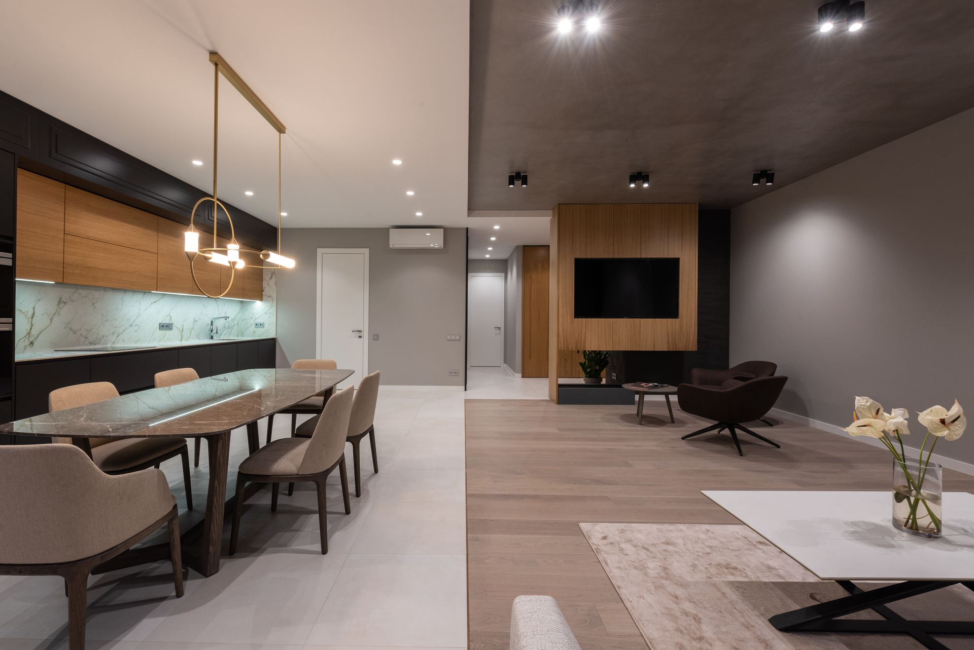Luxurious open plan kitchen and living area with contemporary design elements and elegant decor.