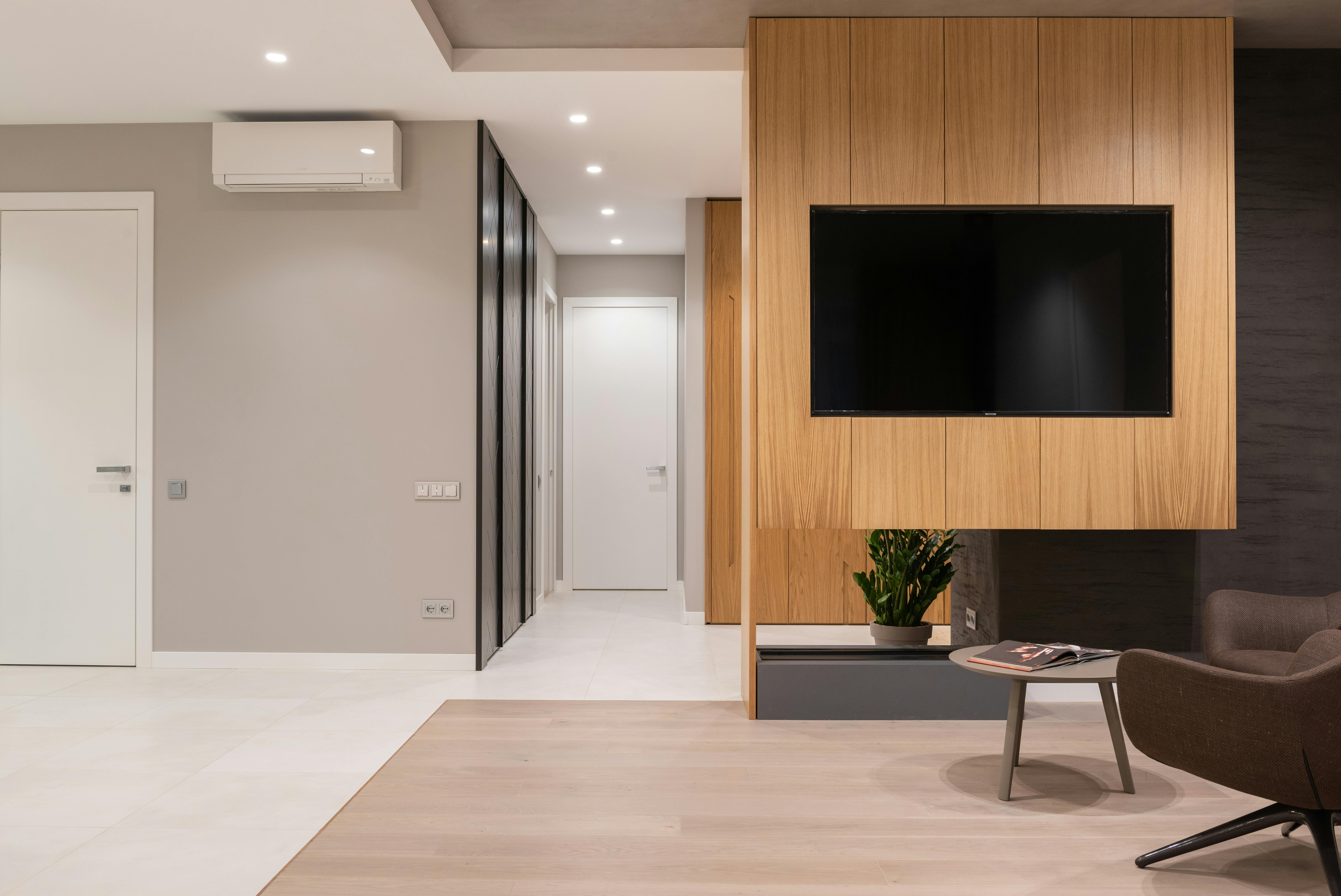 living room with armchair and table near tv