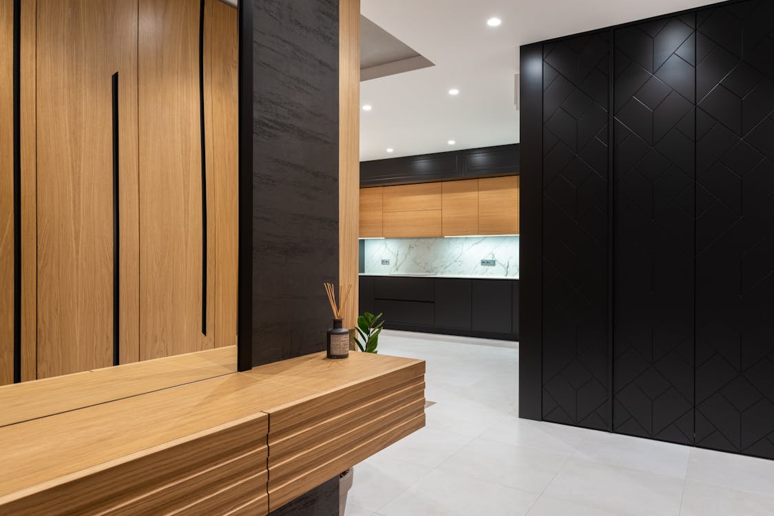 Free Modern Bright House Interior With Cabinets And Mirror In Hall Near Entrance To Kitchen Stock Photo