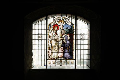Free Intricate stained glass window depicting religious figures in a dark room, Poland. Stock Photo