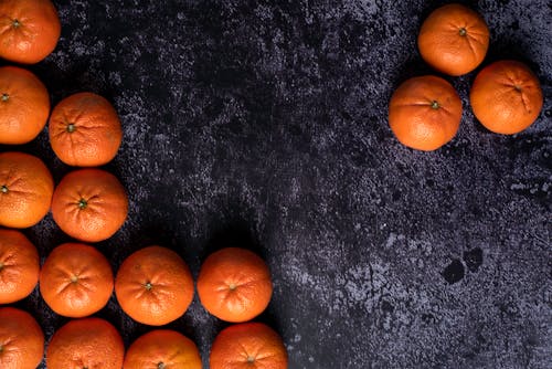 Orange Fruits on Black and Gray Surface
