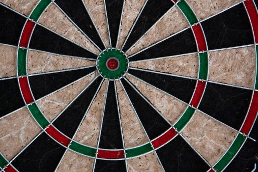 Detailed image of a dartboard focusing on the bullseye and colored rings.