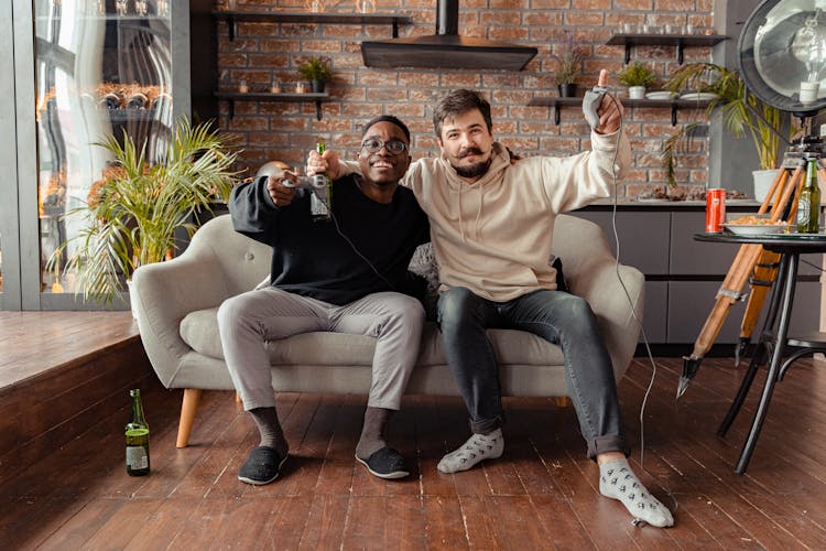 Friends Playing Video Games And Drinking Beer