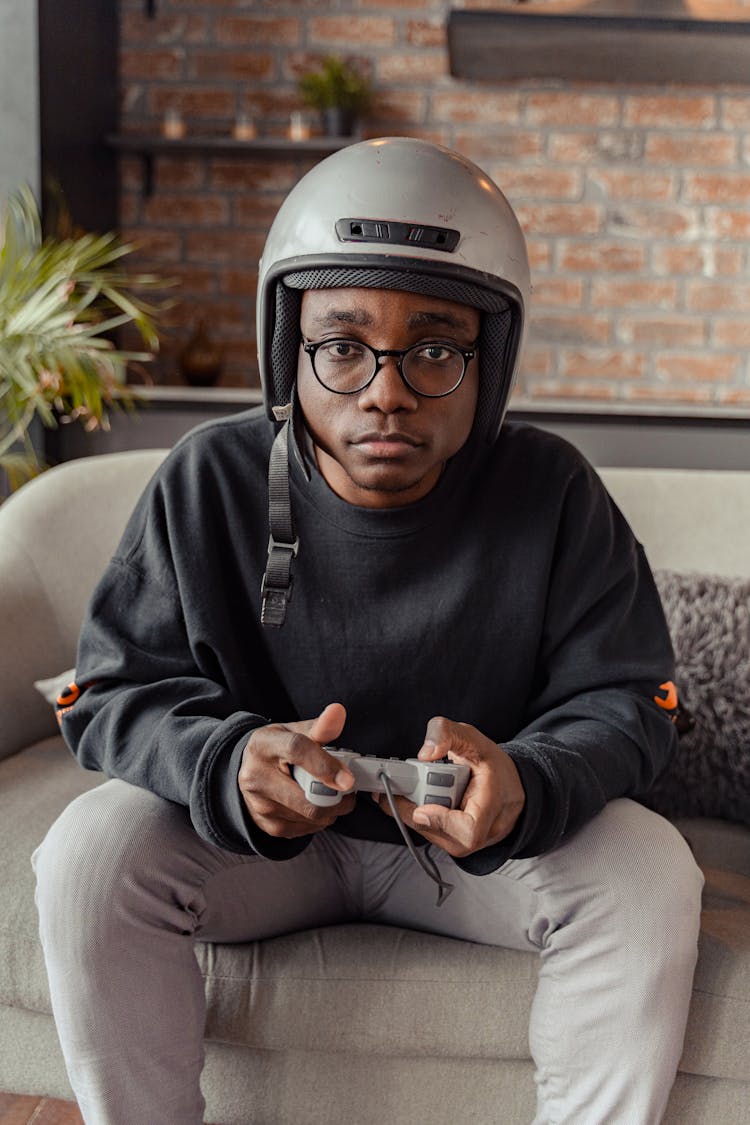 Man With Helmet Holding Game Controller