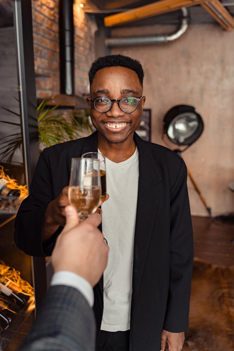 Man In Black Coat Holding Wine Glass