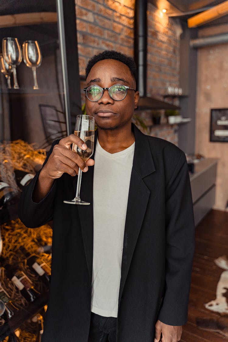 Man In Black Coat Holding Wine Glass