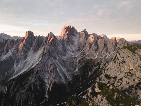 A stunning aerial view capturing a rugged mountain range at sunrise, showcasing natural beauty and dramatic landscapes.