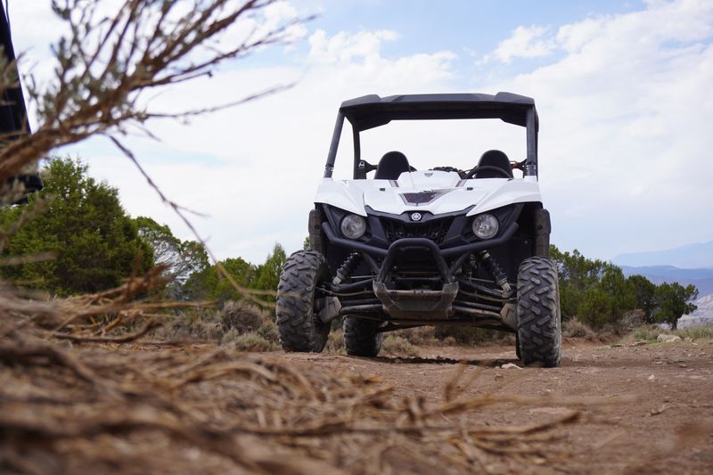 White off-road utility vehicle conquering rugged terrain outdoors