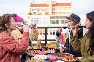 Group of friends toasting on a rooftop terrace