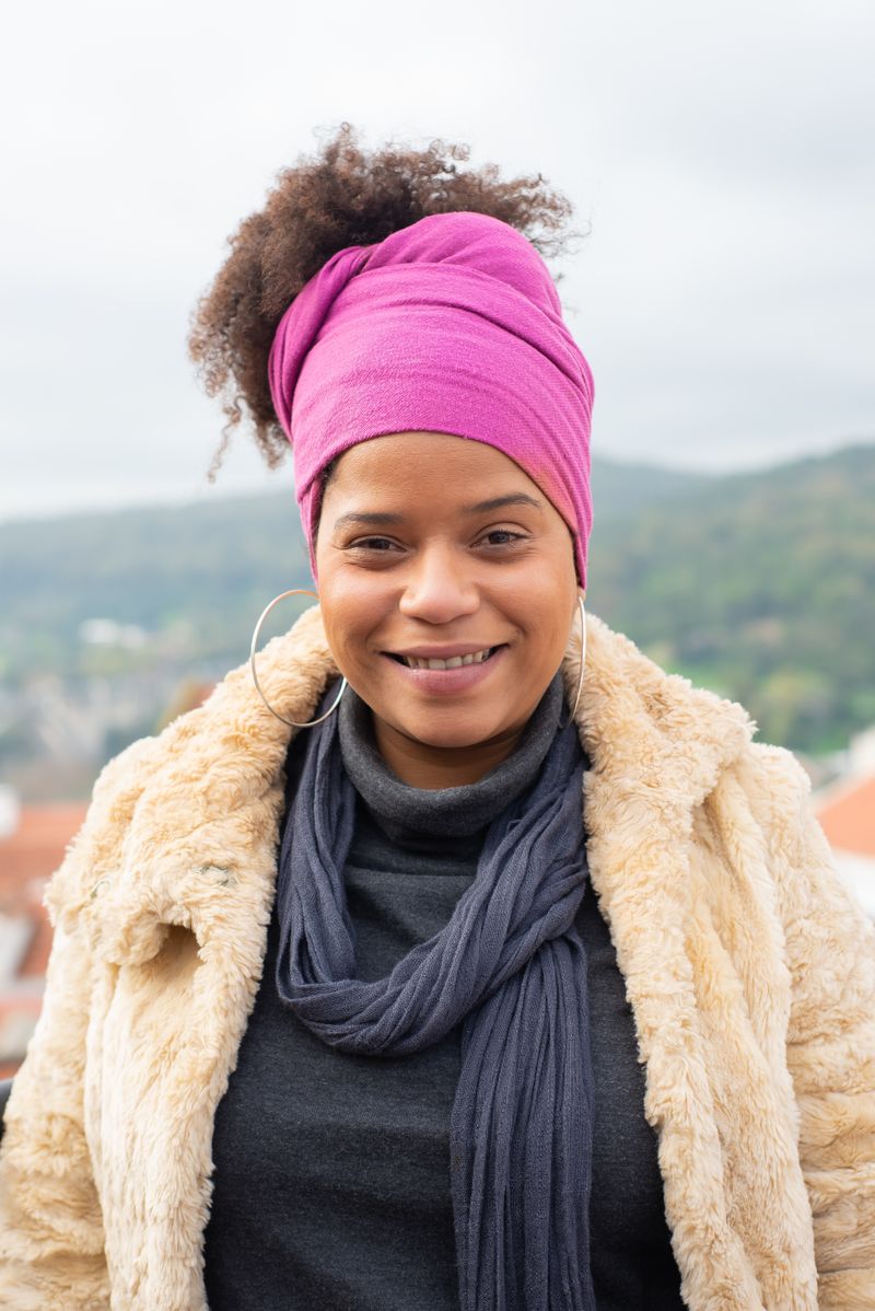 Smiling woman wearing a beige fur jacket