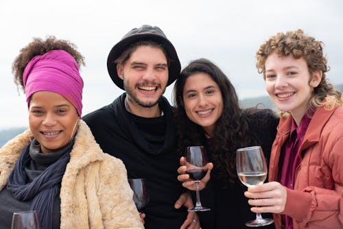 Smiling People Holding Wine Glasses