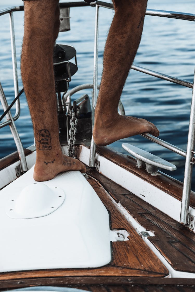 Close-up Of Man Feet Standing On The Boat Prow