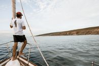 Man Standing in Front of a Sailboat