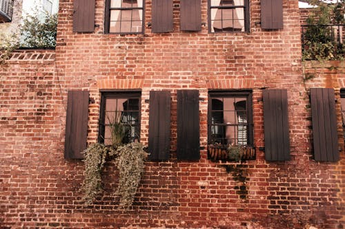 Brown Wooden Frame Glass Windows on Brick Wall