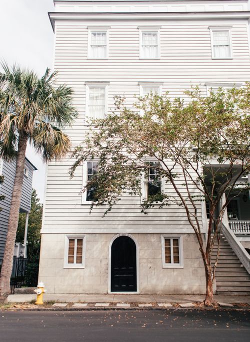 Free Elegant multi-storey building with trees and stairs, capturing southern architectural charm. Stock Photo