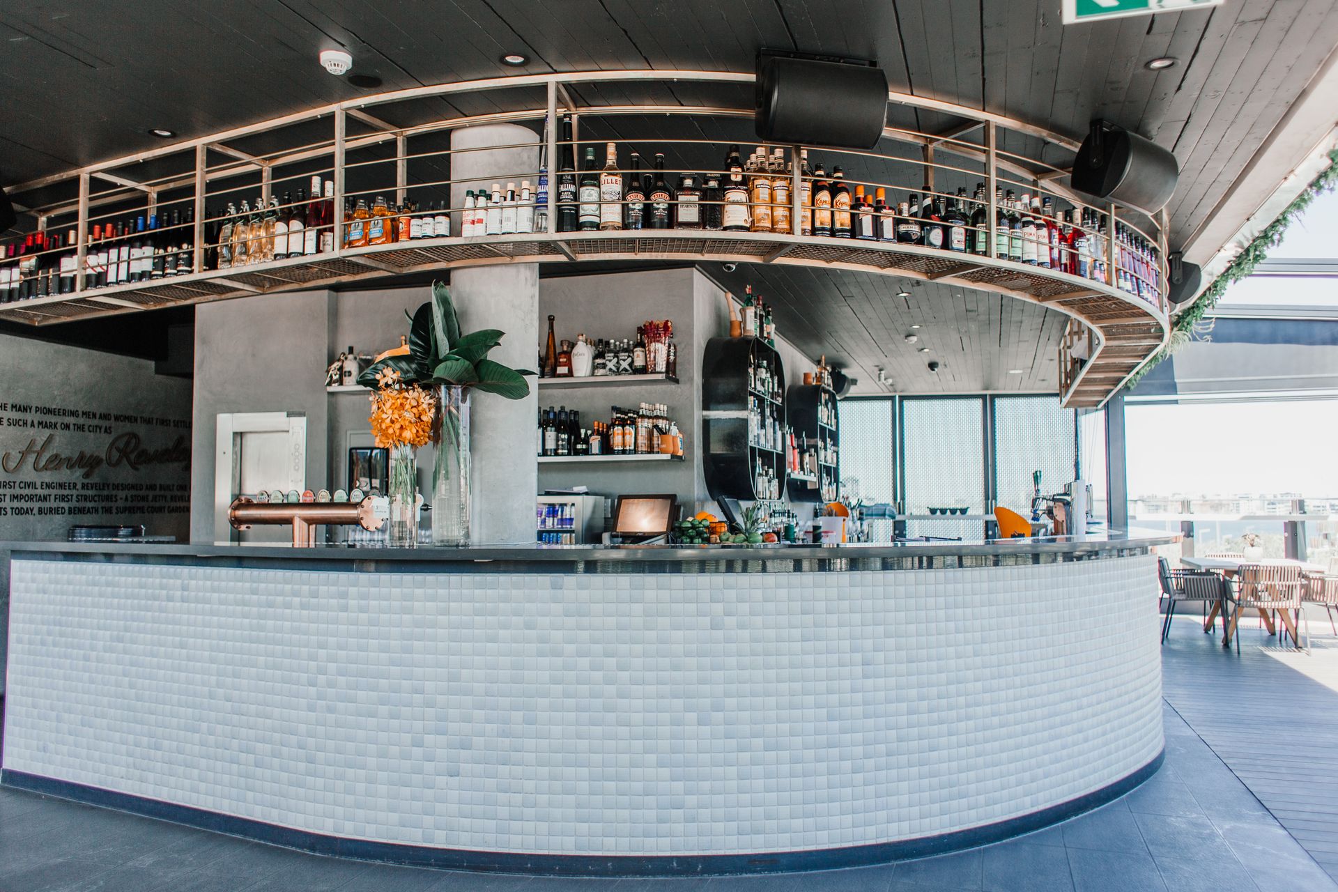 Stylish bar interior with well-stocked shelves and a modern design, perfect for a restaurant setting.