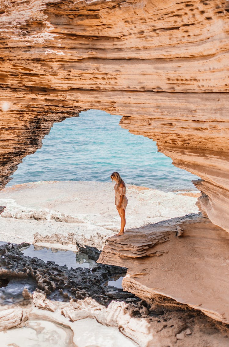 Drone Shot Of A  Woman Standing On A Sandstone