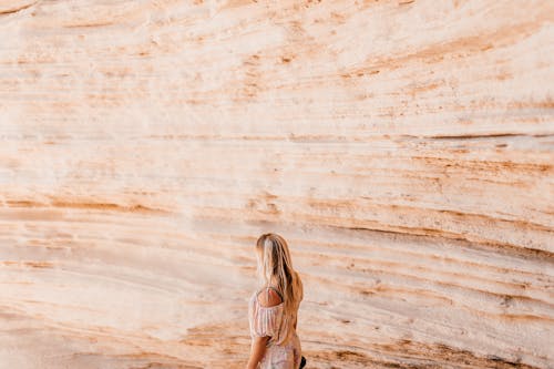 A Woman Standing by a Rock