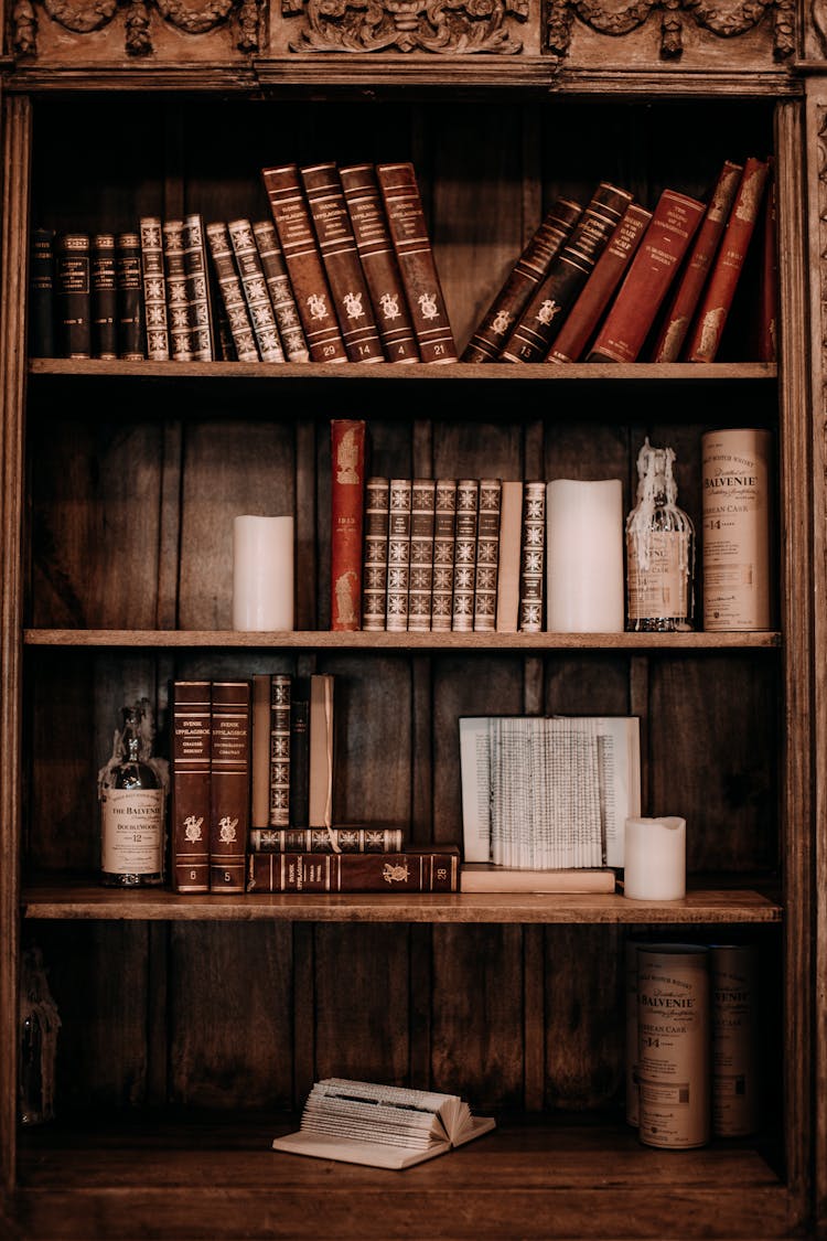 Books Arranged On A Wooden Bookcase