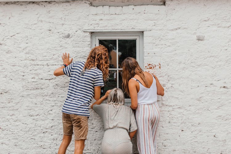 People Peeking Through A Window